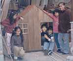 Los niños del tercer grado construyendo una casita de madera.